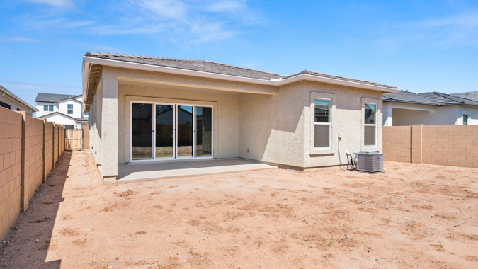 Large fenced-in backyard with a covered patio, perfect for outdoor entertaining.