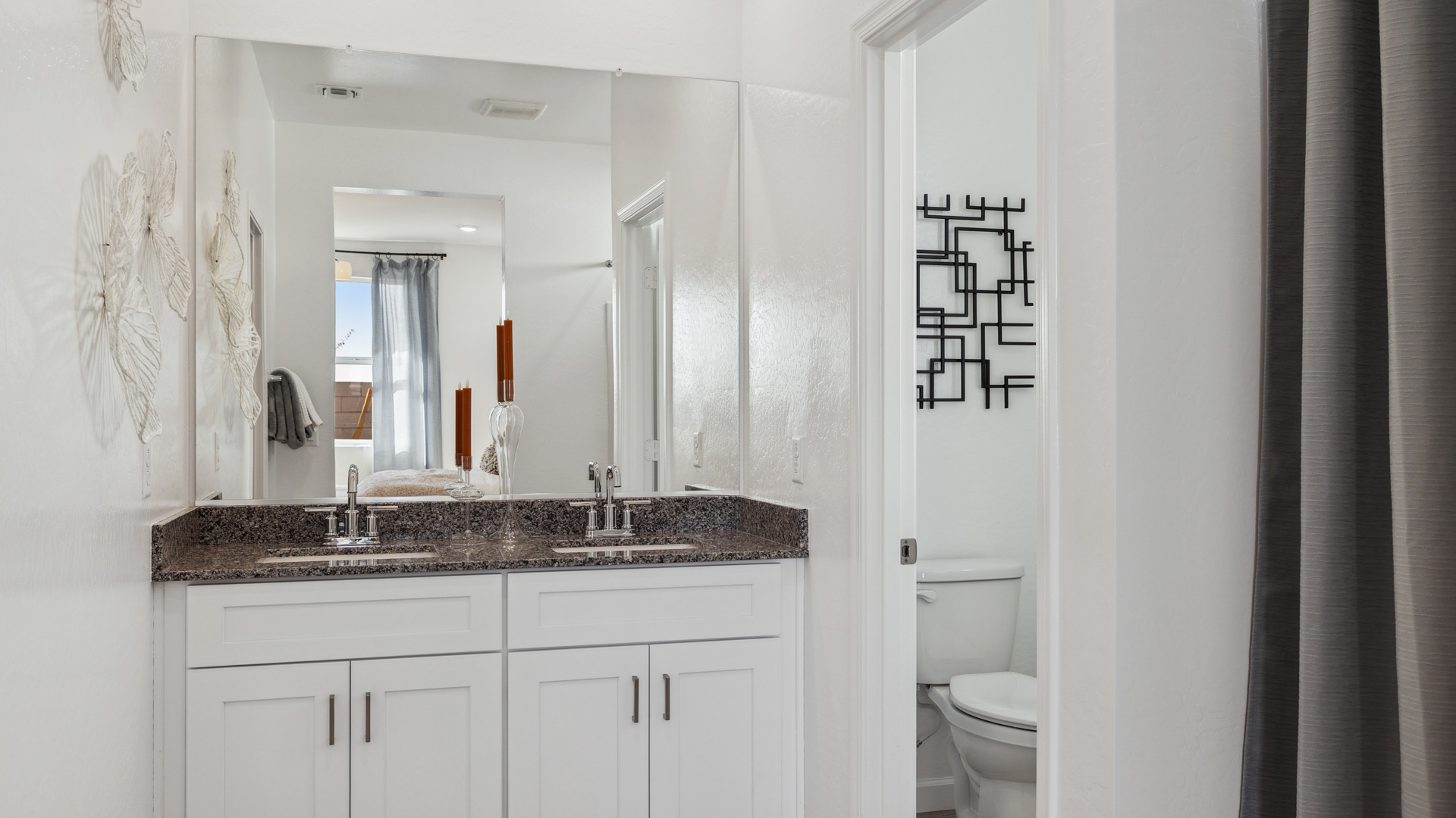 primary bathroom with dual vanities