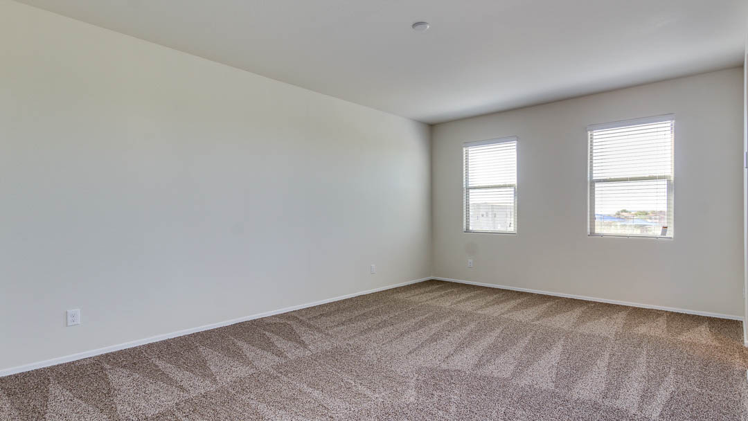 Fuji bedroom with windows and carpet flooring