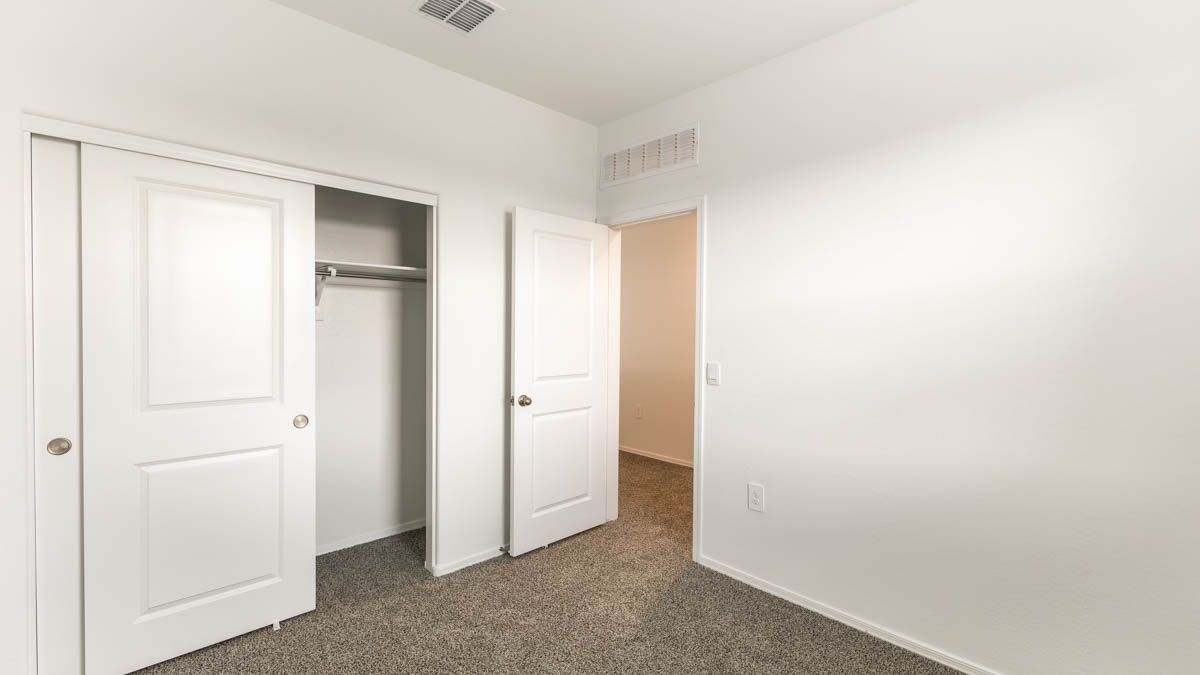 Yosemite bedroom with storage and carpet flooring