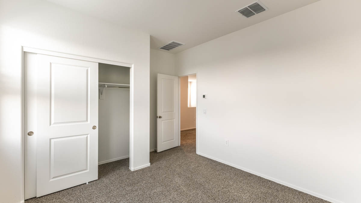 Yosemite bedroom with storage and carpet flooring