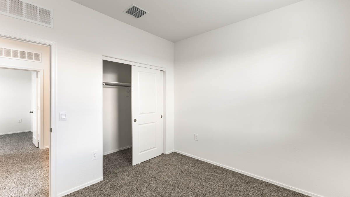 Yosemite bedroom with closet storage and carpet flooring