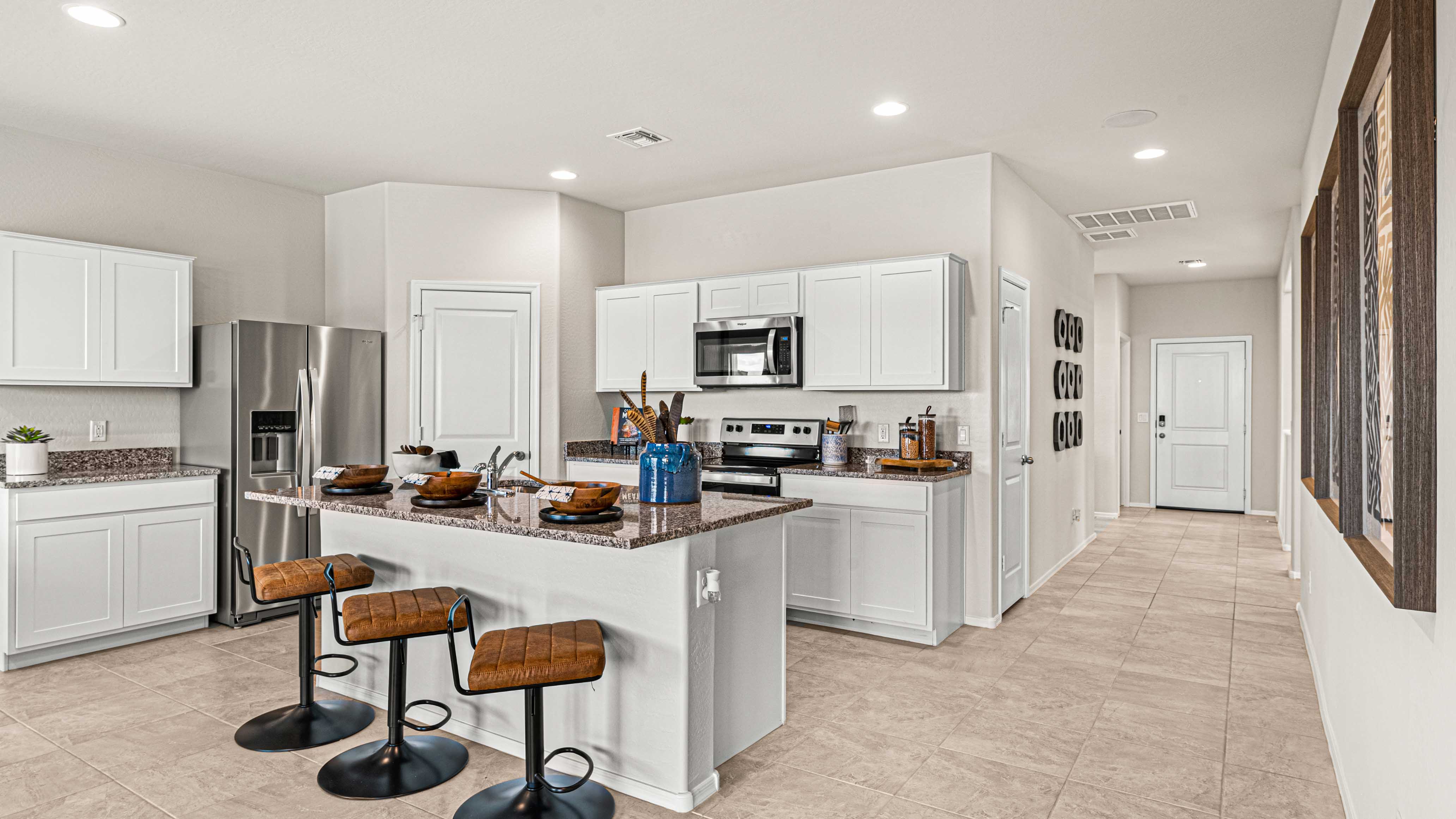 Cali kitchen with white cabinets and corner plantry
