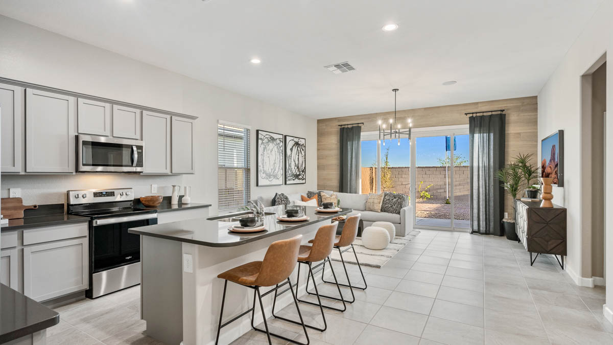 Dove kitchen and great room with sliding glass door to the backyard