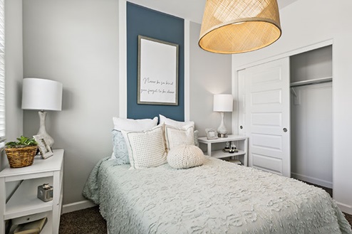 Bedroom with a bed, two nightstands, and a closet.