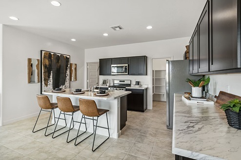 Kitchen featuring brown cabinets, stainless steel appliances, and a large island.