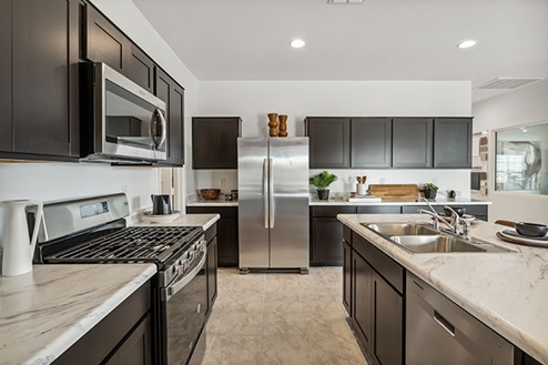 Kitchen featuring brown cabinets, stainless steel appliances, and a large island.