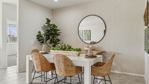 A well-organized living room that includes a kitchen and dining area, creating a warm and welcoming environment for gatherings.