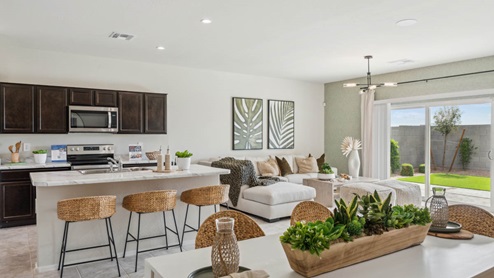 A well-organized living room that includes a kitchen and dining area, creating a warm and welcoming environment for gatherings.