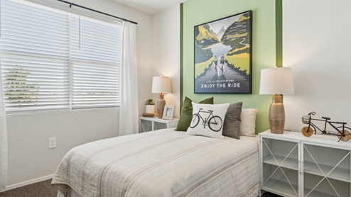 Comfortable guest bedroom featuring neutral-toned walls, carpeted flooring, and a large closet.
