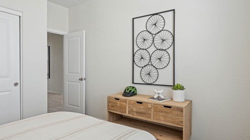 Comfortable guest bedroom featuring neutral-toned walls, carpeted flooring, and a large closet.