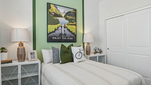 Comfortable guest bedroom featuring neutral-toned walls, carpeted flooring, and a large closet.