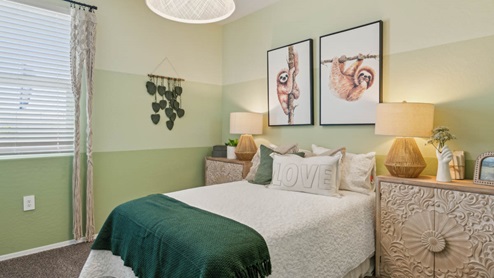 Comfortable guest bedroom featuring neutral-toned walls, carpeted flooring, and a large closet.