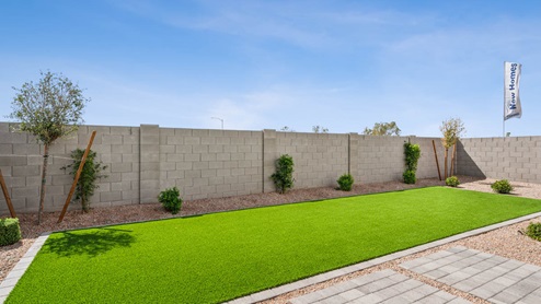 Large fenced-in backyard with a covered patio, perfect for outdoor entertaining.