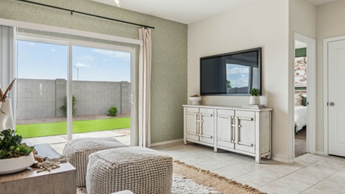 A well-organized living room that includes a kitchen and dining area, creating a warm and welcoming environment for gatherings.