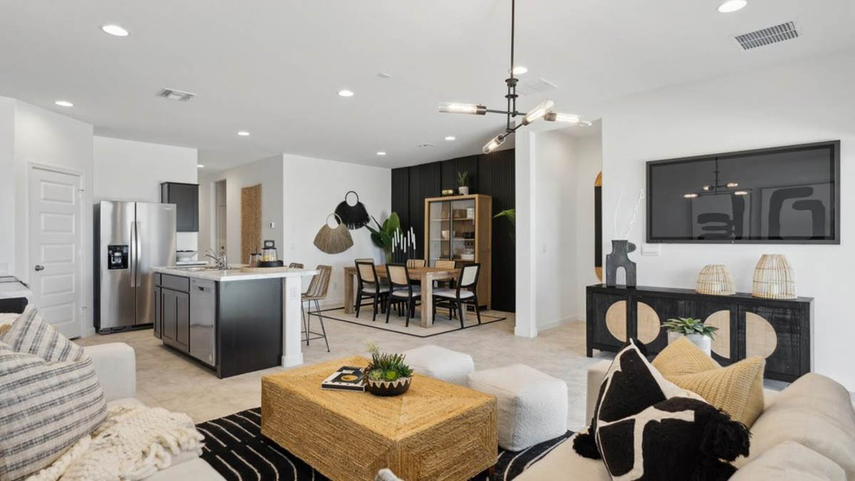 A well-organized living room that includes a kitchen and dining area, creating a warm and welcoming environment for gatherings.
