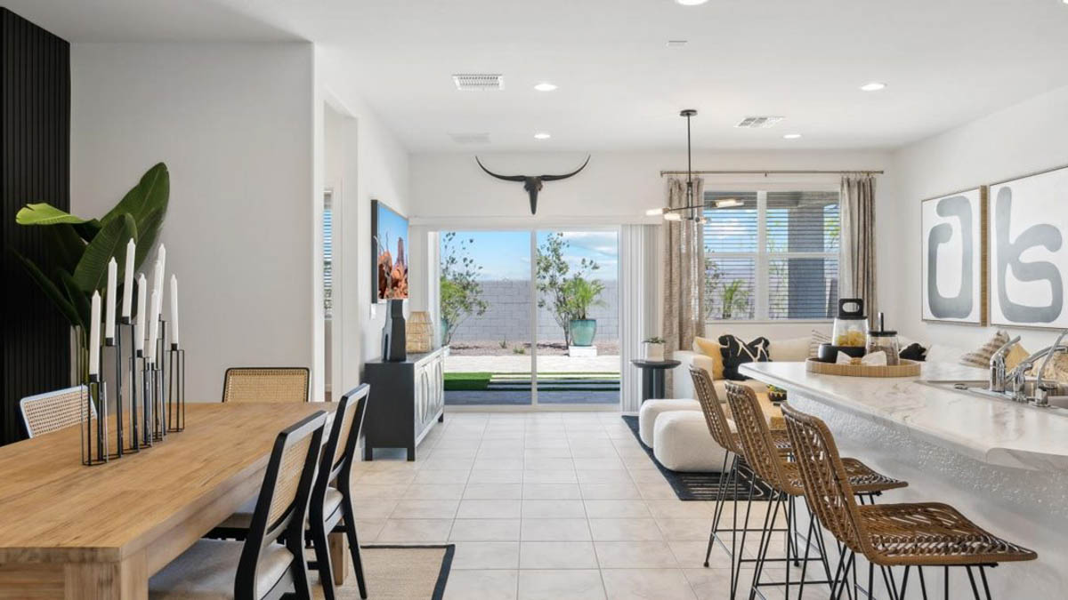 Bright and spacious kitchen with procelain countertops, stainless steel appliances, and an island with bar seating.