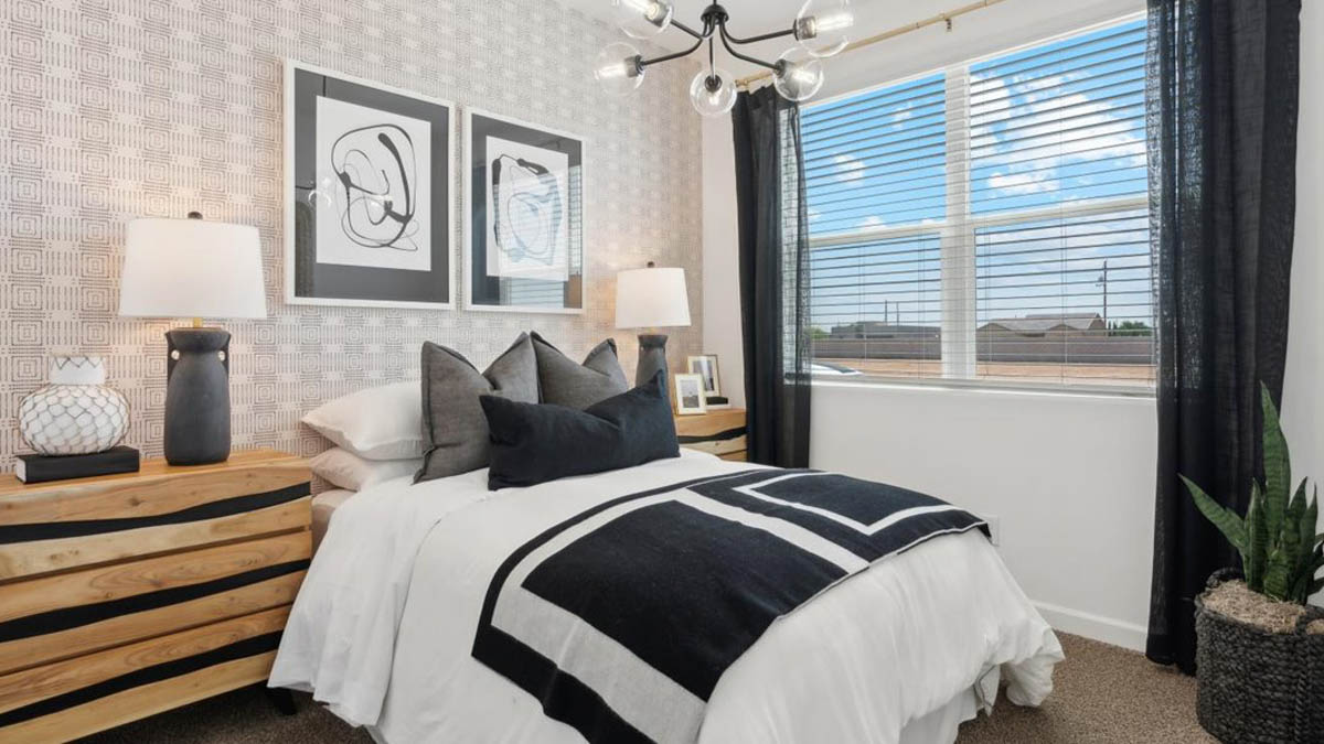 Comfortable guest bedroom featuring neutral-toned walls, carpeted flooring, and a large closet. With secondary bathroom in between bedrooms.