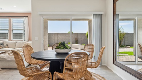 A well-organized living room that includes a kitchen and dining area, creating a warm and welcoming environment for gatherings.