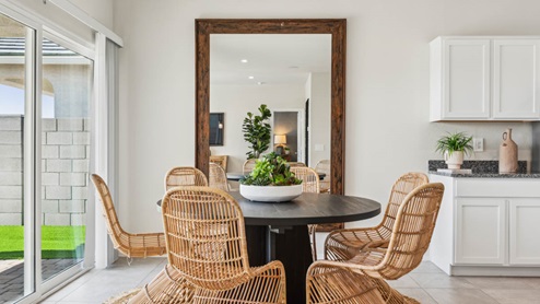 A well-organized living room that includes a kitchen and dining area, creating a warm and welcoming environment for gatherings.