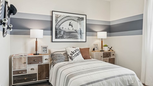 Comfortable guest bedroom featuring neutral-toned walls, carpeted flooring, and a large closet.