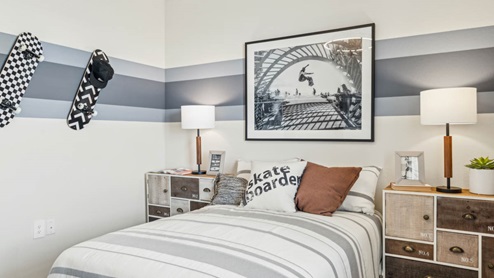 Comfortable guest bedroom featuring neutral-toned walls, carpeted flooring, and a large closet.
