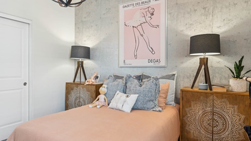 Comfortable guest bedroom featuring neutral-toned walls, carpeted flooring, and a large closet.