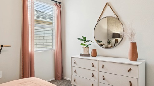 Comfortable guest bedroom featuring neutral-toned walls, carpeted flooring, and a large closet.