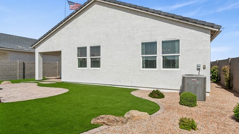 Large fenced-in backyard with a covered patio, perfect for outdoor entertaining.