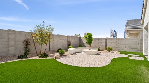 Large fenced-in backyard with a covered patio, perfect for outdoor entertaining.