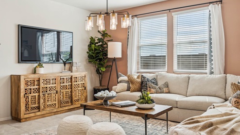 A well-organized living room that includes a kitchen and dining area, creating a warm and welcoming environment for gatherings.