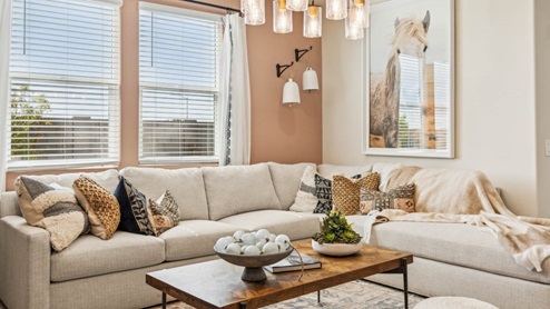 A well-organized living room that includes a kitchen and dining area, creating a warm and welcoming environment for gatherings.