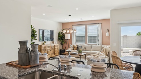 Bright and spacious kitchen with granite countertops, stainless steel appliances, and an island with bar seating.