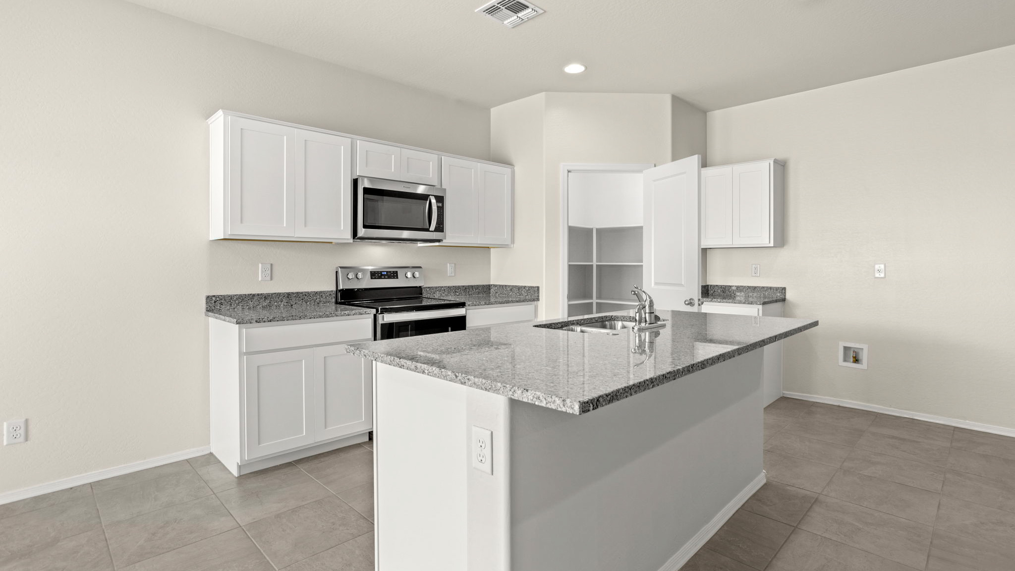 Baxter kitchen with white cabinets and tile flooring