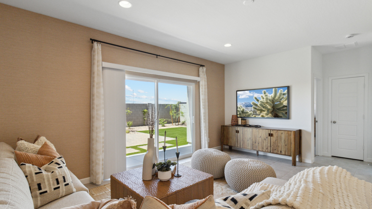 Living room with windows facing the backyard and connected access to kitchen and dining areas Heartland Ranch