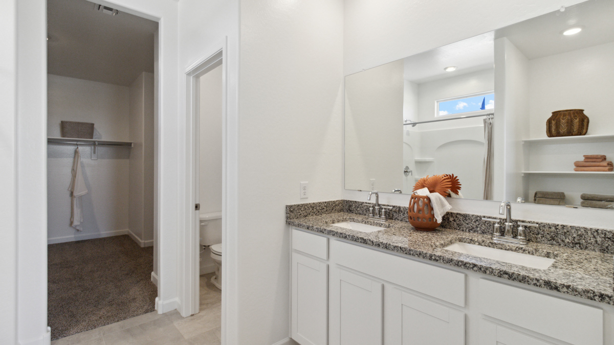 Owner’s ensuite offering spa-inspired finishes, dual vanity, and walk-in closet access Heartland Ranch