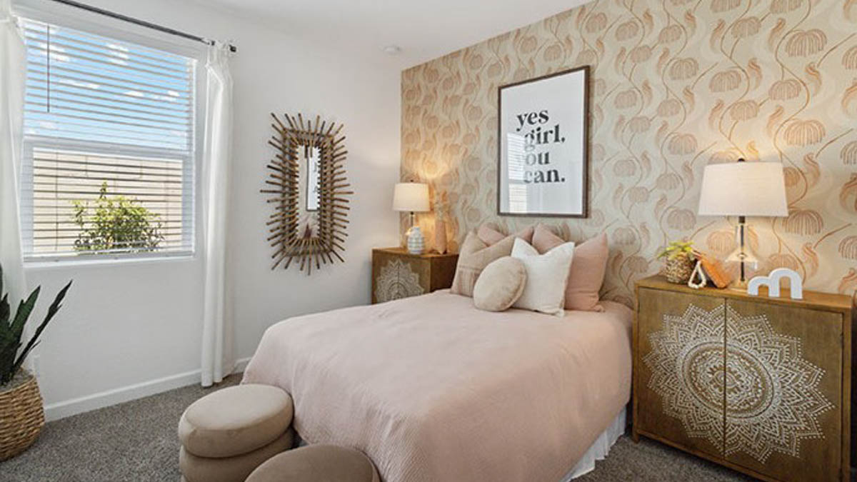 Primary bedroom features ample space, double windows, soft carpet, a stylish walk-in closet, and a private ensuite bath