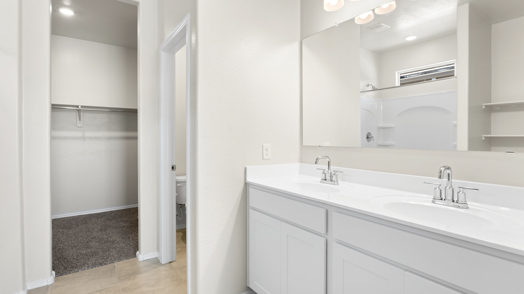 Fargo bathroom with white cabinets and storage