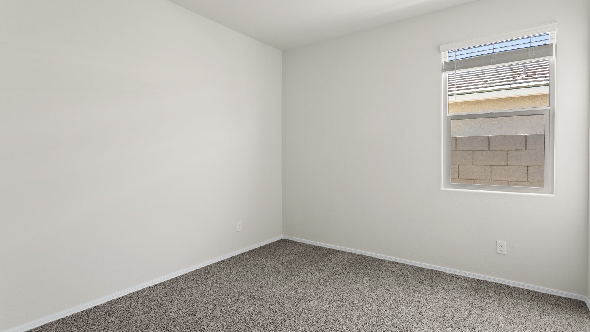 Fargo bedroom with windows and carpet flooring