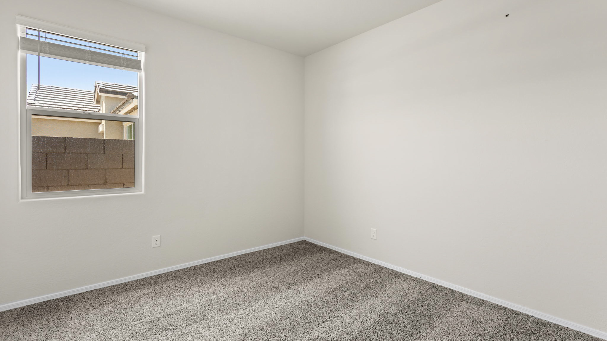 Fargo bedroom with windows and carpet flooring