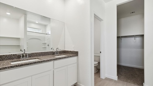 Justin bathroom with white cabinets and storage