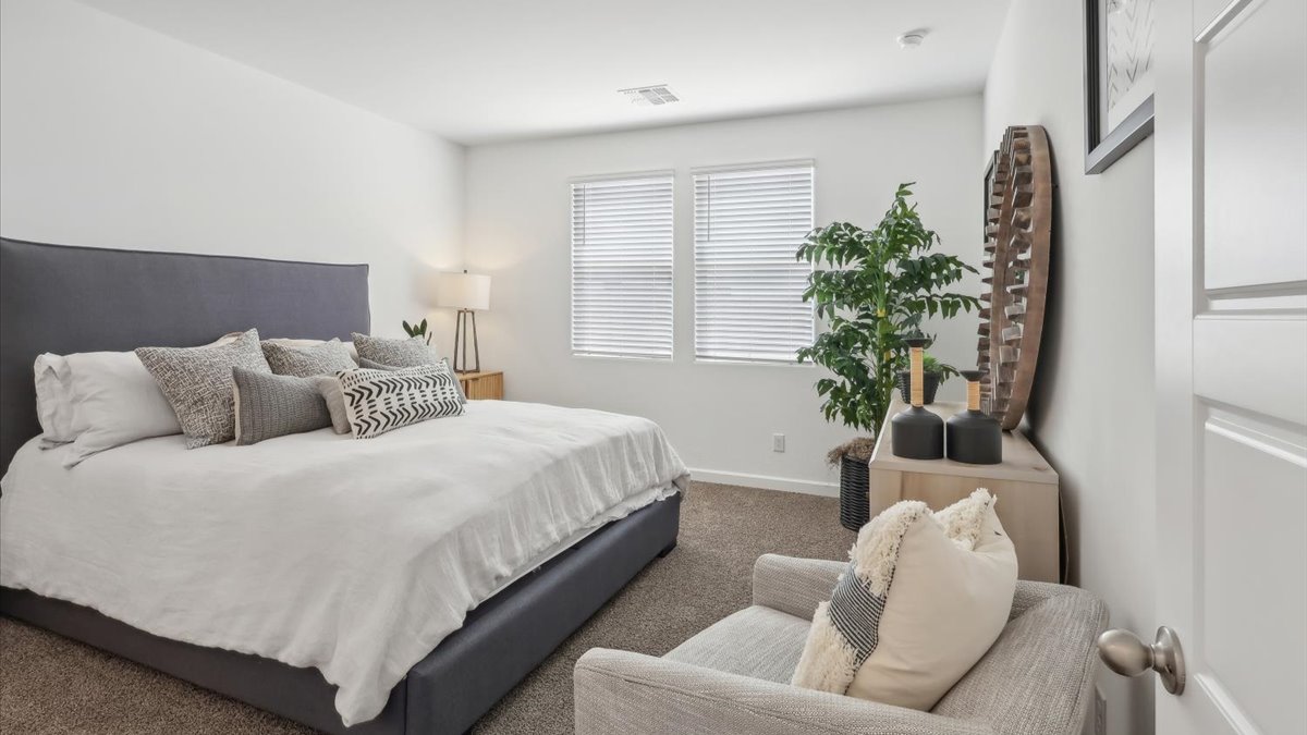 Taylor bedroom with windows and carpet flooring