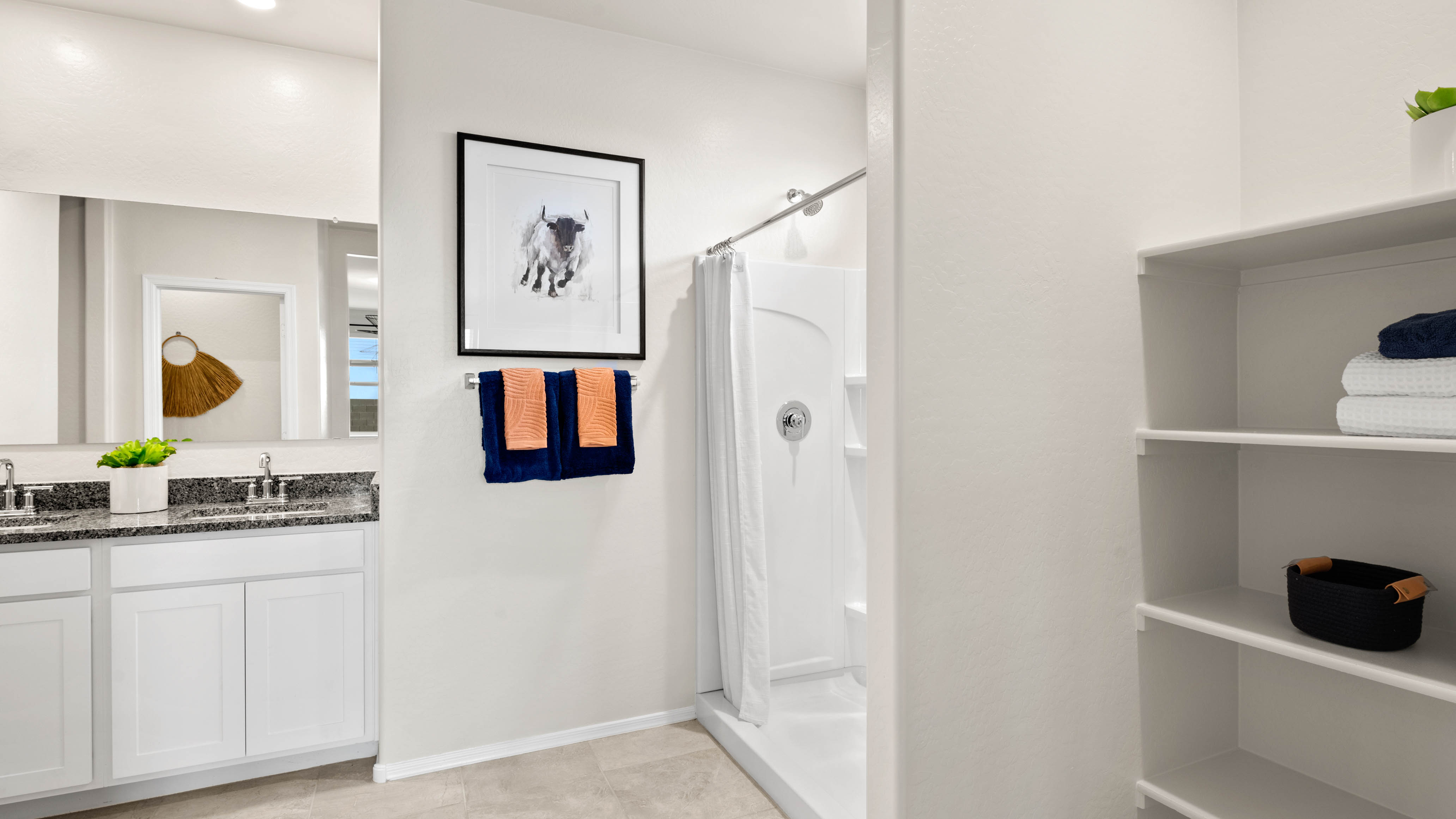 Cali bathroom with storage and white cabinets