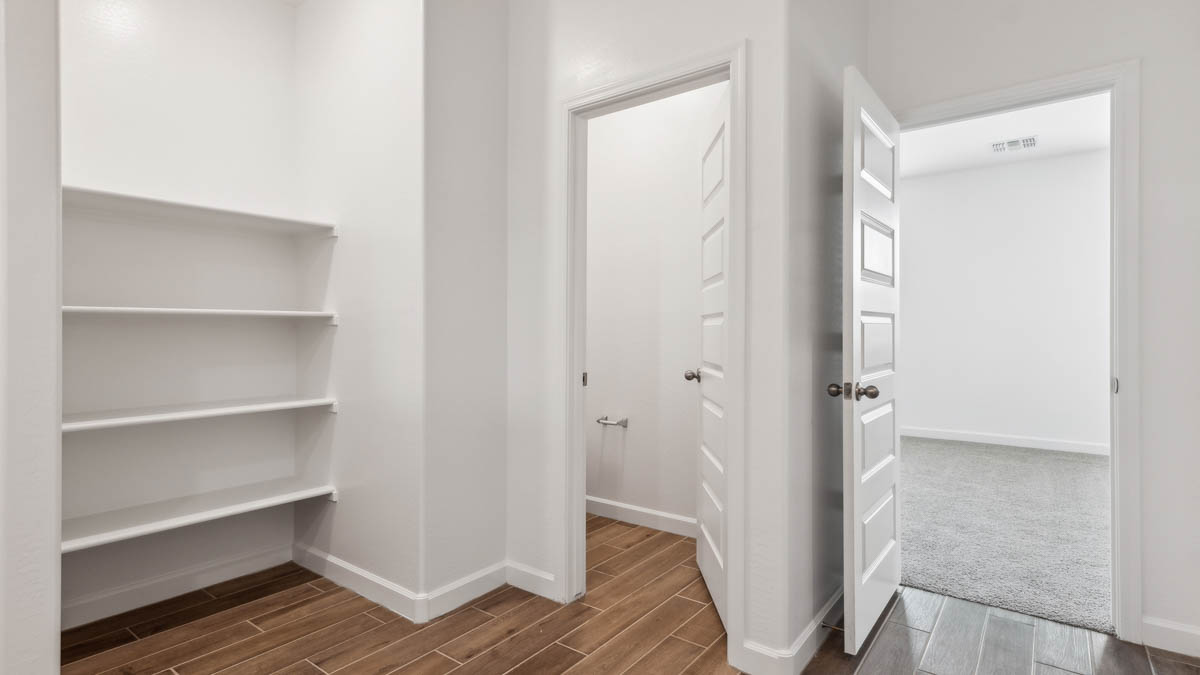bathroom with dual vanity sinks, toilet, and a walk in shower