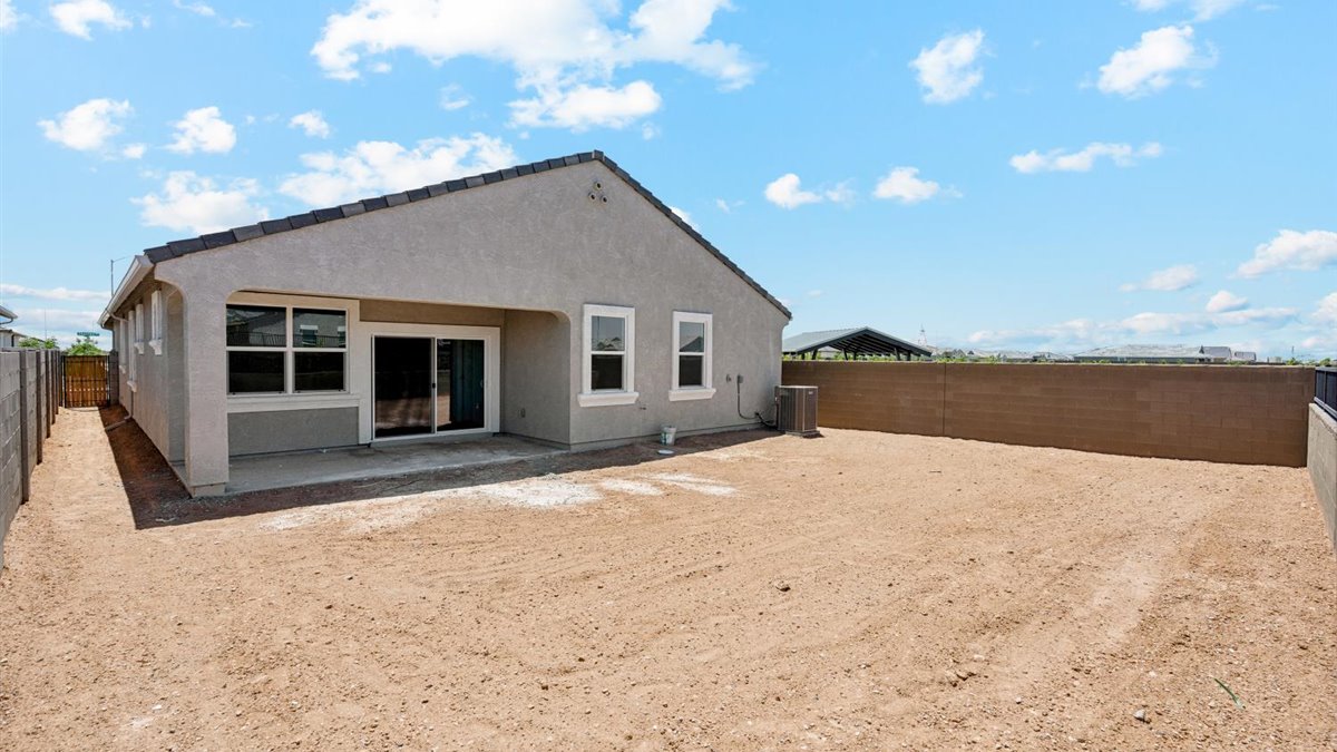 rear exterior of home featuring a spacious fenced in backyard