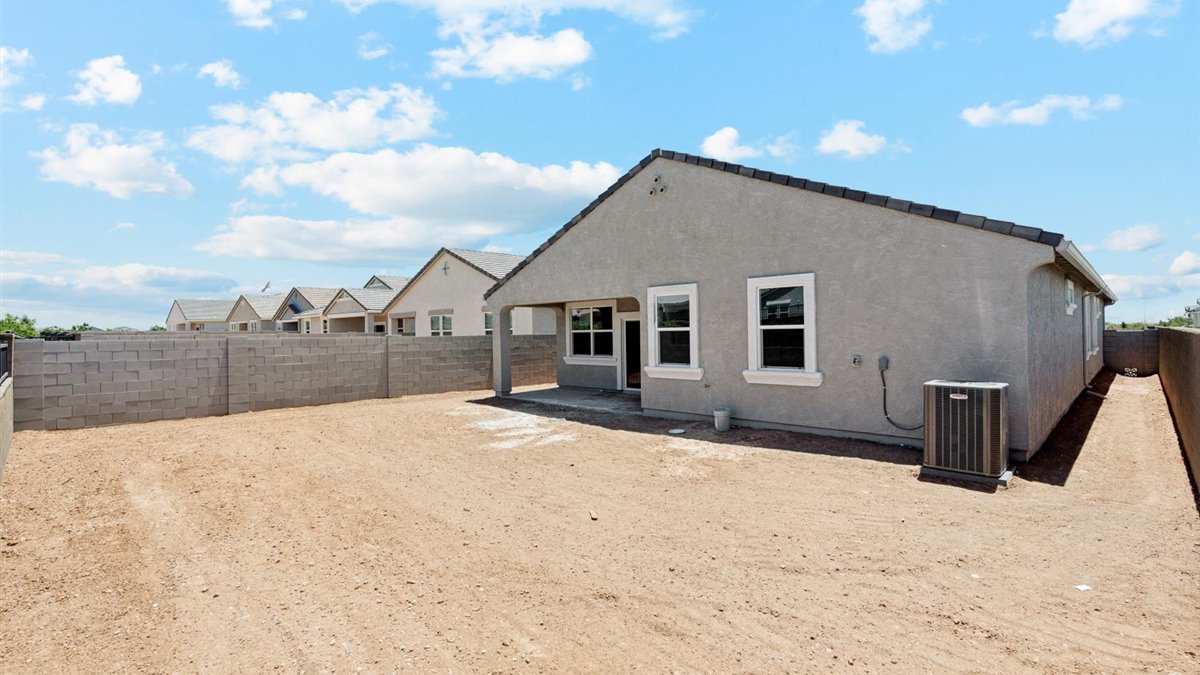 rear exterior of home featuring a spacious fenced in backyard