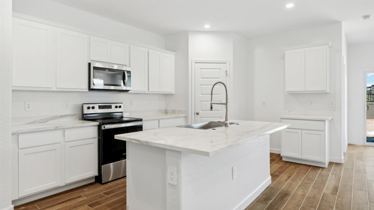 kitchen with white cabinetry, large island, and stainless steel appliances