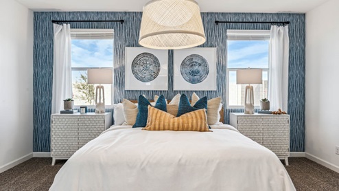 A spacious primary bedroom emphasizing open space and natural lighting