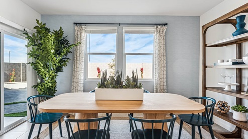 Formal dining room with large windows and view of the backyard.