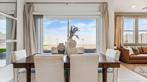 Denton dining area overlooking patio onto large backyard